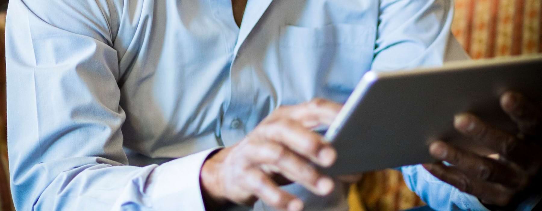 a man holding a tablet