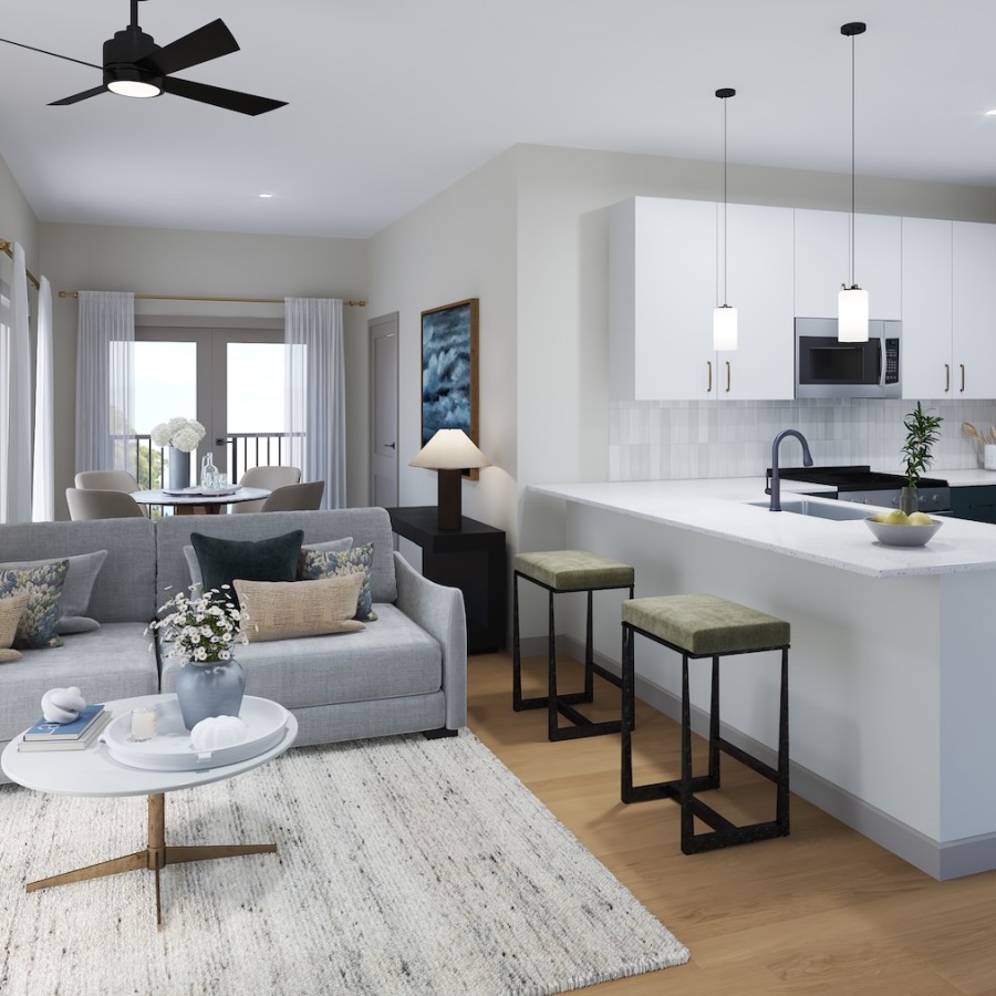 an living room and kitchen with seating and ceiling fan